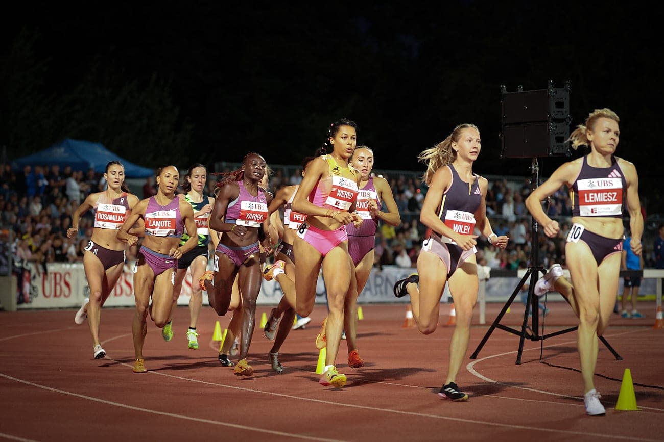 Middle-distance runners racing on the track, the kind of training group that can track training load without wearables